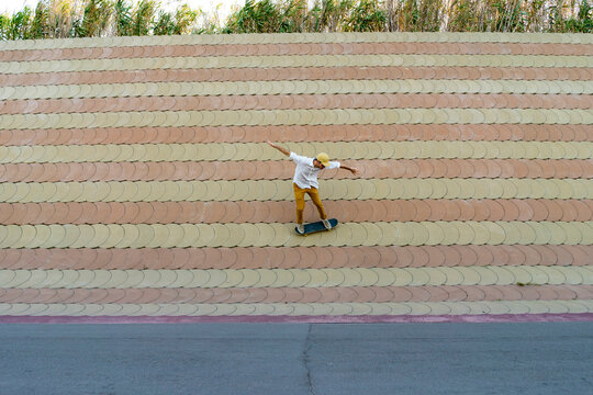 Young man riding skateboard on a wall