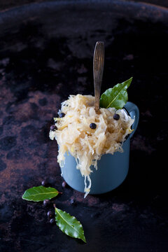 Cup of Sauerkraut with uniper berris and bay leaves