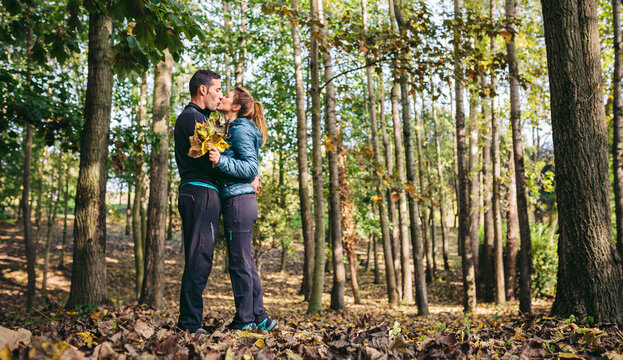 Couple kissing in the autumnal forest