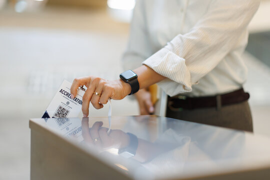 Businesswoman scans access card at corporate office security check