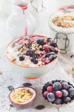 Bowl of vegan coconut yogurt with berries, puffed amaranth, pumpkin seeds and raspberry pulp