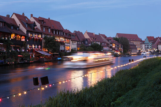 Germany, Bavaria, Franconia, Upper Franconia, Bamberg, View of city with boat in Regnitz river