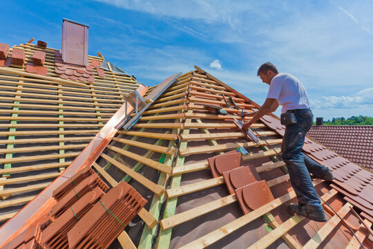 Germany, Baden-Wuerttemberg, Stuttgart, Mid adult man measuring roof tile