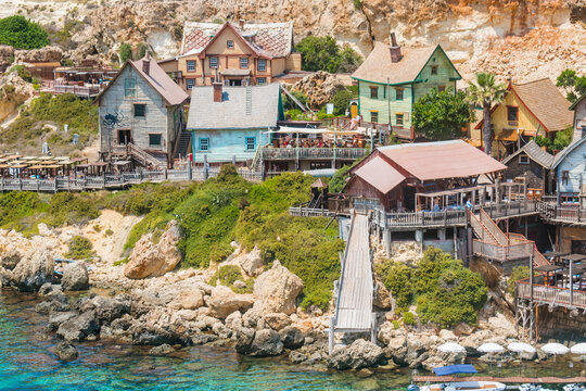 Colorful wooden houses with terraces pathways in cliff in Popeye Village, Mellieha MALTA