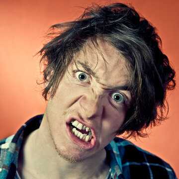 Man making anger faces, portrait