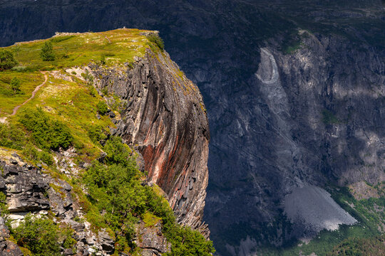 A beautiful exposed rock cliff facing towards a valley. A summer landscape of a protected nature reserve Kallskaret in World Heritage Area in Western Norway.