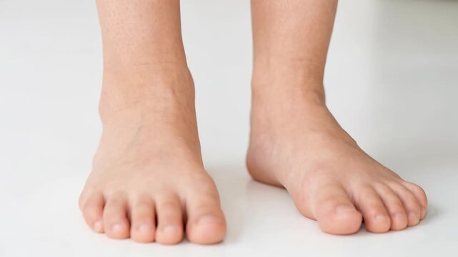 Child's feet are shown in four frames with various poses. The setting is a studio with a plain white background. The focus is on foot placement and structure