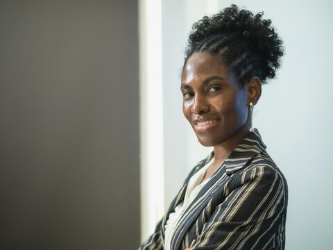 Visionary Female Executive Modern Tech Office. confident Black businesswoman stand high-end corporate digital dashboard embodying inclusive leadership professional success modern workspace innovation.