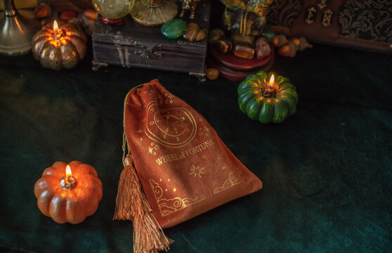 Mystical occult background with tarot cards, burning pumpkin candles, and esoteric attributes Halloween ritual