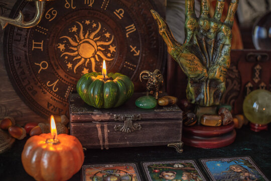 Mystical occult background with tarot cards, burning pumpkin candles, and esoteric attributes Halloween ritual