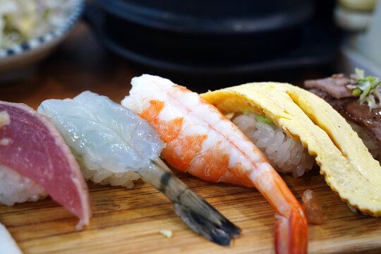 Top view of assorted premium sushi platter on a wooden board