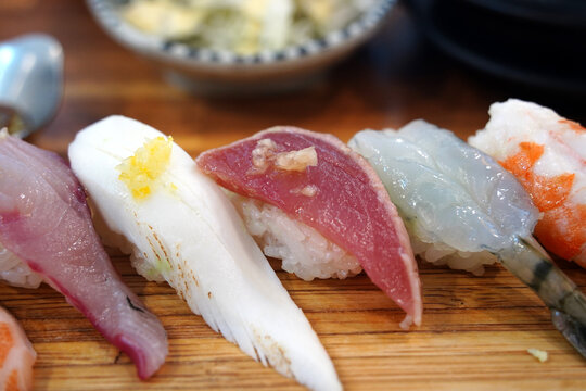 Top view of assorted premium sushi platter on a wooden board