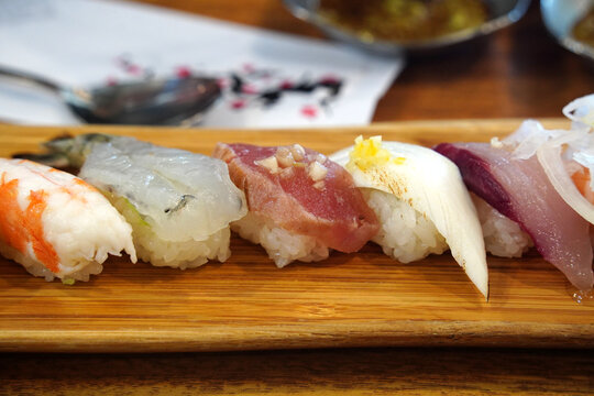 Top view of assorted premium sushi platter on a wooden board