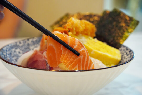 Japanese kaisendon seafood rice bowl topped with salmon, tuna, shrimp tempura, and tamago