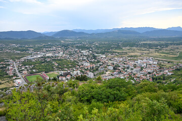 Fototapeta premium Panoramic view of Ljubuski town with houses, buildings, and streets. Aerial drone shot of Ljubuski cityscape in Bosnia and Herzegovina. Townscape of Ljubuški.
