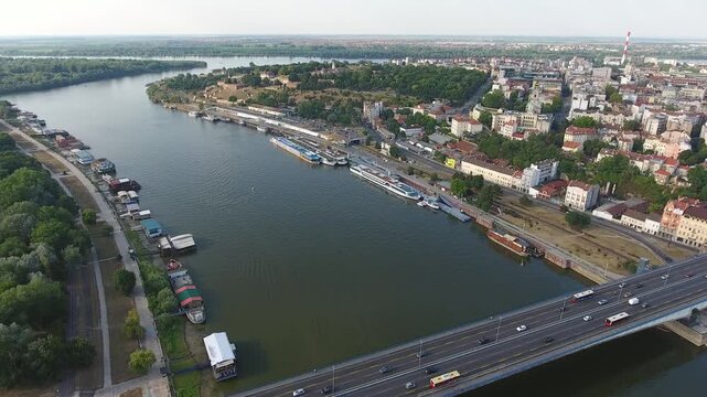 Aerial view of the Belgrade Fortress and the Sava river confluence with boats moored along the banks and traffic crossing the bridge in Belgrade, City of Belgrade, Serbia.
