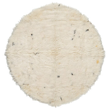 Round cream colored moroccan beni ourain wool rug with dark speckled pattern isolated on a transparent background