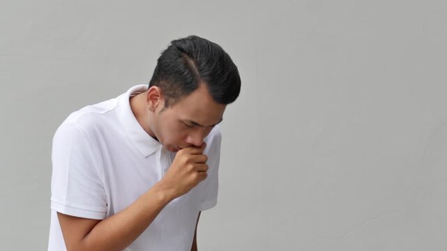 Asian man with cough and flu symptoms, unwell and tired