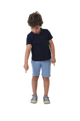 Fototapeta premium front view of a boy dressed in summer clothes standing and pointing down on white background (6 year old)