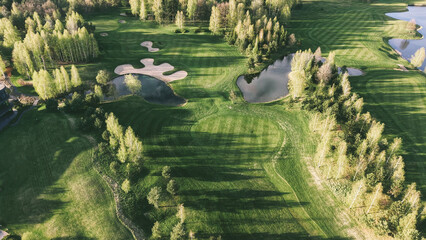Exclusive golf resort landscape in warm evening sunlight