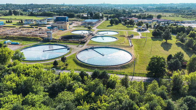 Circular storage tanks in industrial water facility dusk