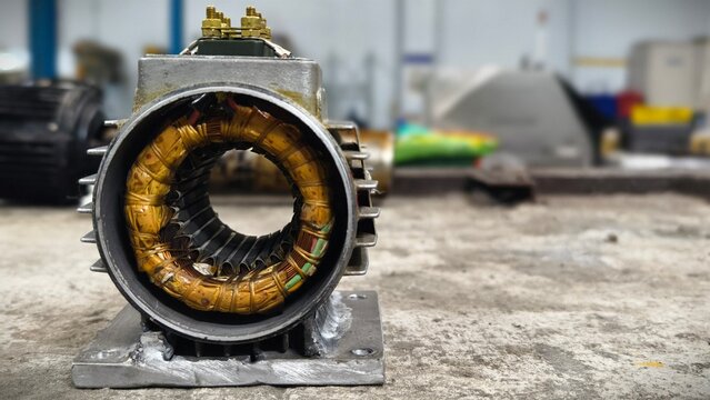 Close-up of an Electric Motor Stator with Copper Windings, Industrial Repair Workshop Background