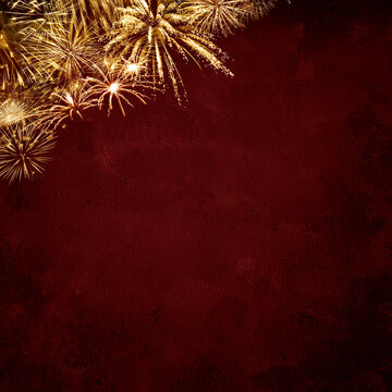 Golden fireworks on red grunge background for New Year