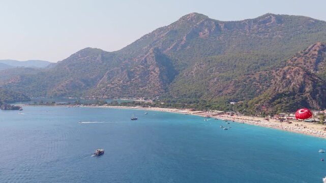 Aerial footage of parasailing along the Turkish coastline in summer