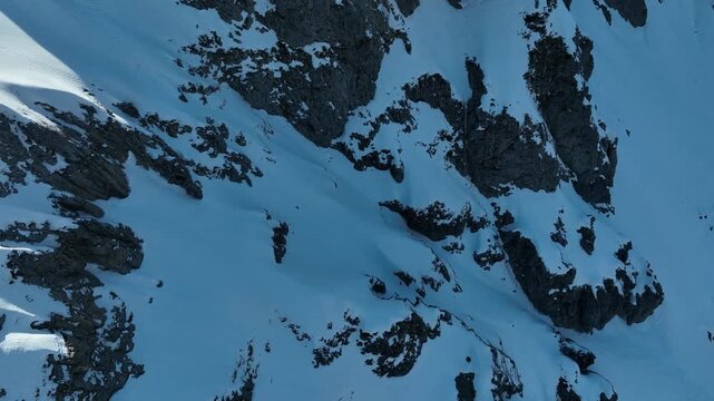 Aerial view of the snow-covered rocky slopes of Pania della Croce in the Apuan Alps, Stazzema, Tuscany, Italy.