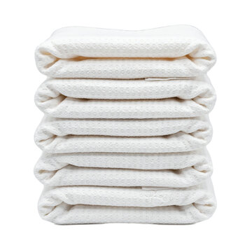 A stack of folded white waffle weave cotton towels arranged vertically isolated on a transparent background