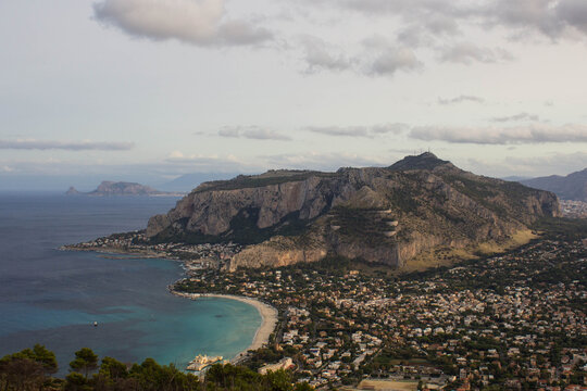 Aerial panoramic view of Mondello Bay and Monte Pellegrino near Palermo, Sicily. Crystal-clear waters, dramatic coastal cliffs and Mediterranean scenery create an attractive travel and tourism destina
