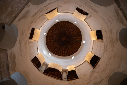 Zadar, Croatia - 15 August 2018: View of the interior of the Church of St. Donatus, featuring its distinctive circular stone walls, arched windows, and wooden domed ceiling.