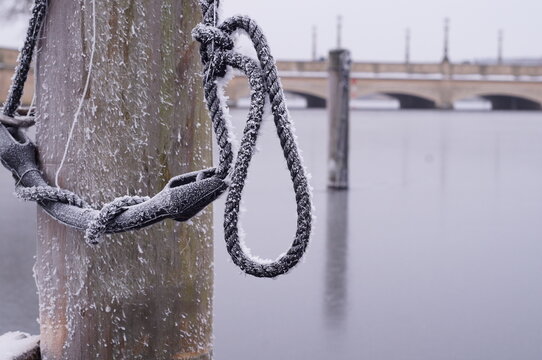 Frozen mooring rope covered with frost at a winter marina