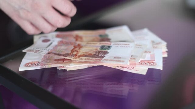 the girl holds in her hands 5000 Russian banknotes 5000 rubles
