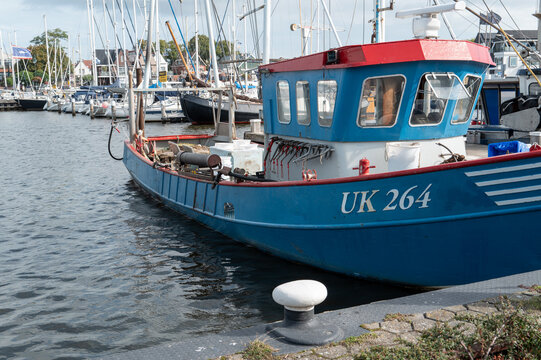 Urk, Flevoland, Netherlands, Fishing boat docked at the harbor with other boats nearby during a sunny day