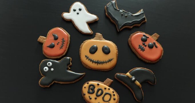 Lots of Halloween gingerbread cookies in a plate on a dark background. Homemade Halloween gingerbread cookies
