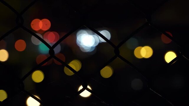 bokeh road abstract night city lights with bokeh through a fence