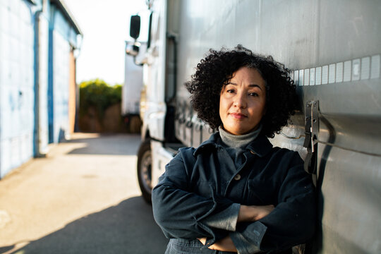 Confident woman truck driver at logistics depot