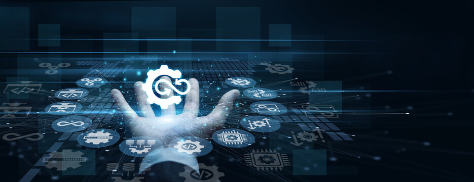 Software engineer handhold DevOps icon displaying continuous integration cycles. Programmer using dual monitors analyzing automated deployment pipelines and software testing. Agile workflows.