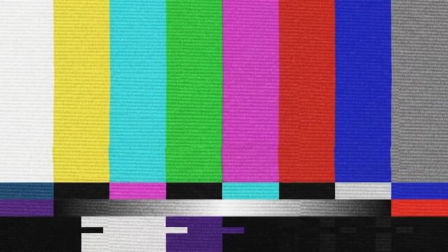 Classic television color bar test pattern with static and grainy texture, indicating signal loss or broadcast interruption.