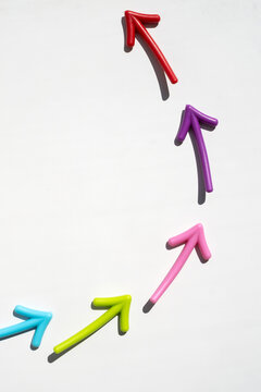 Colorful arrows forming upward trend isolated on white background for business growth progress and success concept