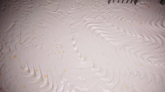4k close up footage of mechanic arms mixing hot milk at the dairy factory. closeup of wire frames rotating in automated heating vat at cheese plant, cutting yellow mass into pieces and separating it f