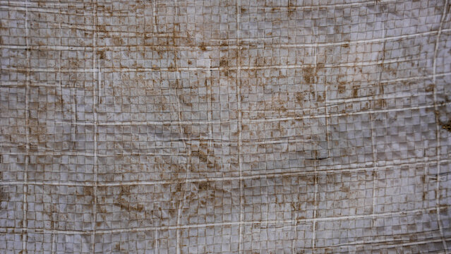 Weathered stone wall texture with grid pattern and rustic grey masonry blocks