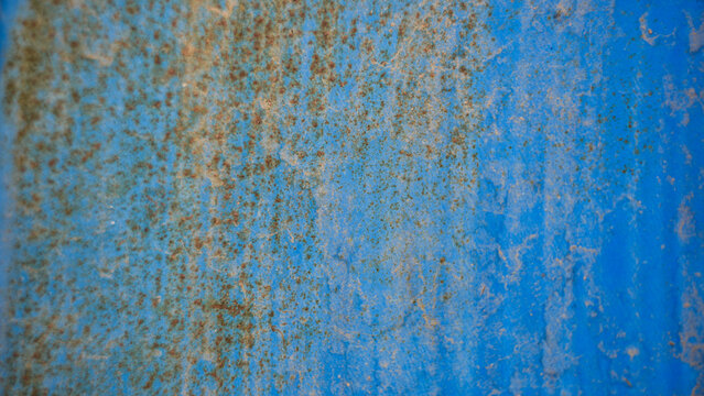 Weathered blue metal surface with rust texture and peeling paint background