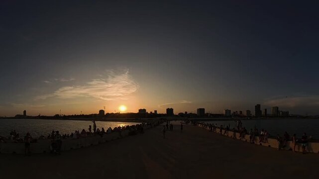 Timelapse of the total solar eclipse  at sunset, taken from the Bac de Roda breakwater on Barcelona beaches. 