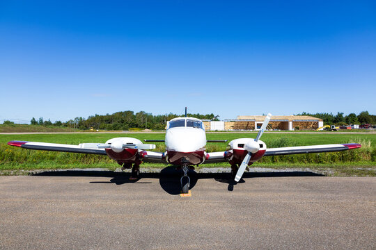 Neuville, Quebec, Canada, August 29, 2026 - Frontal view of a 70s red and white Piper Aztec F twin engine piston aircraft&nbsp;displayed during a public event