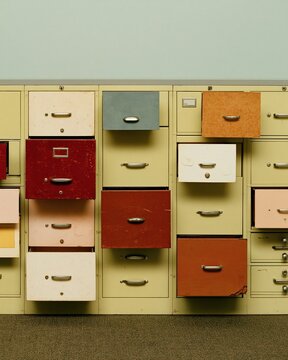 Hardware store parts drawer cabinet with distressed vintage paper swatches, featuring scuffed lacquer and aged textures for archive branding and copy space