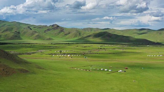 Aerial view of Orkhon Valley Natural and Historical Reserve with traditional gers scattered across the green landscape in Xarxorin, Ovorkhangai, Mongolia.