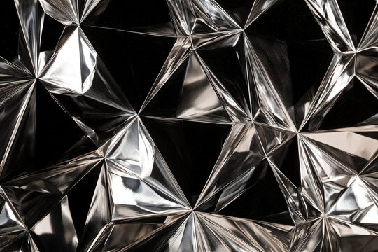 Abstract geometric metallic surface with shimmering light and shadow
