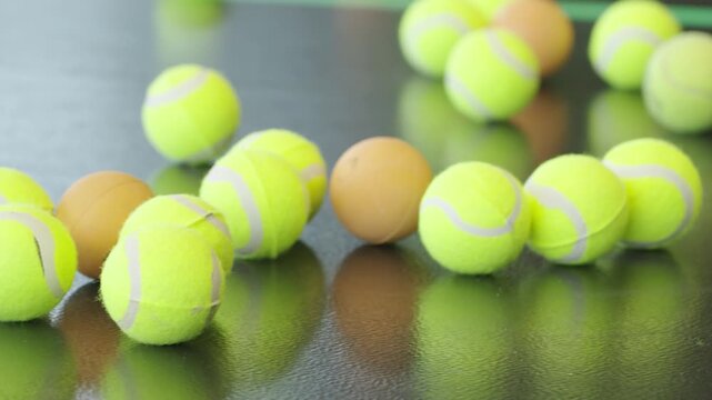 Hand carefully picking up tennis ball